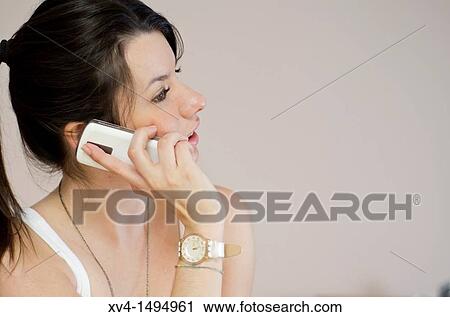Teenage girl talking on her mobile phone View Large Photo Image Stock Image - Teenage girl talking on her mobile phone. Fotosearch