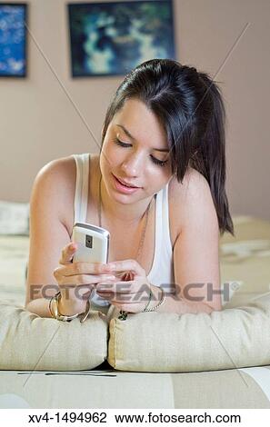 Stock Image - Teenage girl talking on her mobile phone. Fotosearch