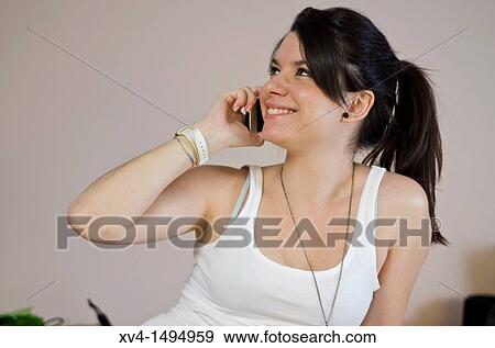 Teenage girl talking on her mobile phone View Large Photo Image Stock Photo - Teenage girl talking on her mobile phone. Fotosearch