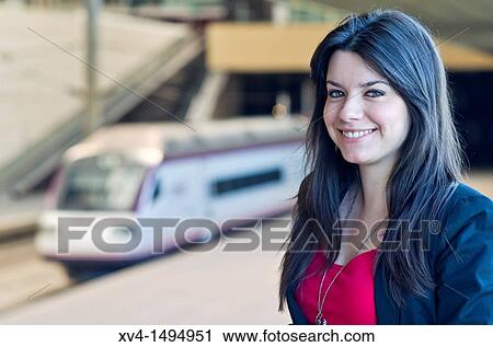 Stock Image - Teenage girl waiting in train station. Fotosearch