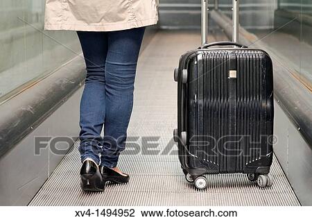 Stock Image - Teenage girl waiting in train station. Fotosearch