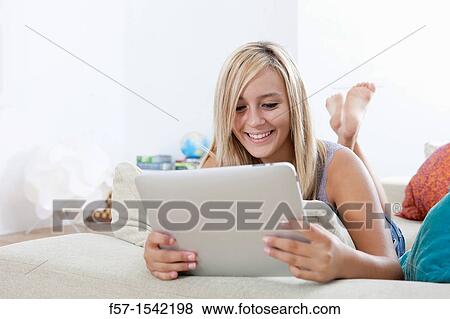 Stock Photo - Teenage girl with tablet. Fotosearch