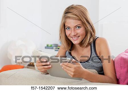 Teenage girl with tablet View Large Photo Image Stock Photo - Teenage girl with tablet. Fotosearch