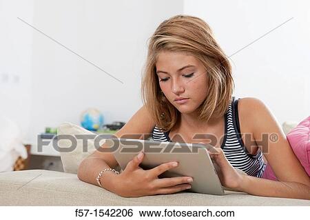 Teenage girl with tablet View Large Photo Image Stock Photograph - Teenage girl with tablet. Fotosearch