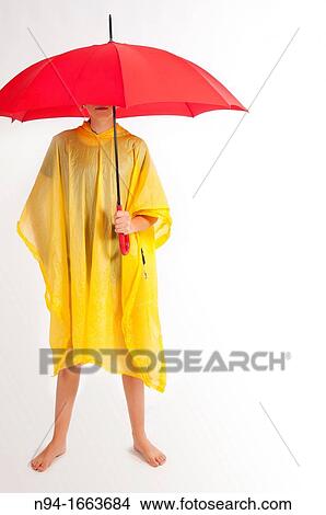 Teenage girl with yellow rain gear protected with red umbrella. View Large Photo Image Picture - Teenage girl with yellow rain gear protected with red umbrella.. Fotosearch