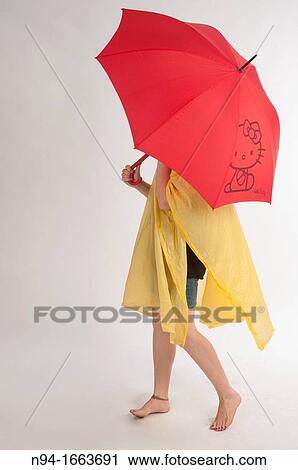 Teenage girl with yellow rain gear protected with red umbrella. View Large Photo Image Stock Image - Teenage girl with yellow rain gear protected with red umbrella.. Fotosearch