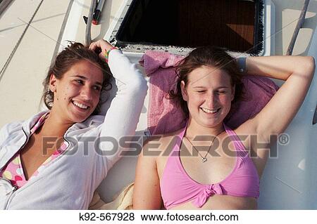 Teenage girls on a sailboat View Large Photo Image Stock Photo - Teenage girls on a sailboat. Fotosearch