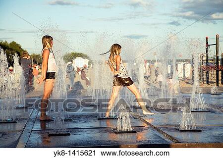 Stock Image - Teenage Girls on Beach Promenade in P? rnu, Estonia, Europe. Fotosearch