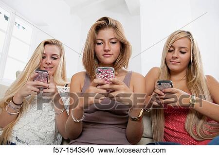 Teenage girls texting on their Blackberry? s View Large Photo Image Stock Image - Teenage girls texting on their Blackberry? s. Fotosearch