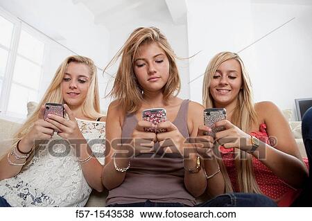 Teenage girls texting on their Blackberry? s View Large Photo Image Stock Photo - Teenage girls texting on their Blackberry? s. Fotosearch