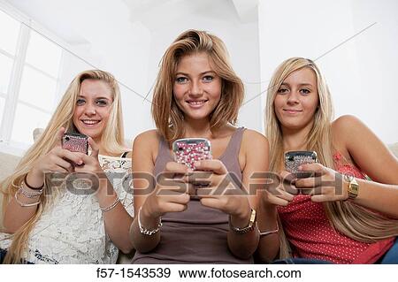 Teenage girls texting on their Blackberry? s View Large Photo Image Stock Photo - Teenage girls texting on their Blackberry? s. Fotosearch