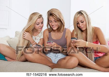 Teenage girls texting on their Blackberry? s View Large Photo Image Stock Photograph - Teenage girls texting on their Blackberry? s. Fotosearch