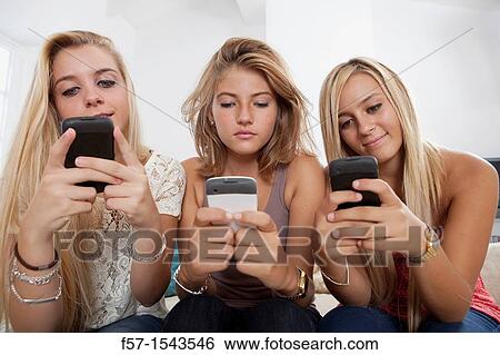Teenage girls texting on their Blackberry? s View Large Photo Image Stock Photograph - Teenage girls texting on their Blackberry? s. Fotosearch