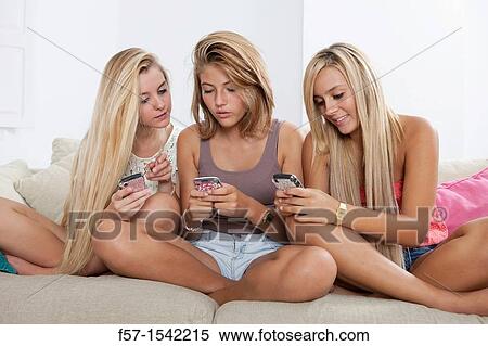 Teenage girls texting on their Blackberry? s View Large Photo Image Stock Photography - Teenage girls texting on their Blackberry? s. Fotosearch