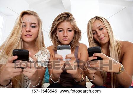 Teenage girls texting on their Blackberry? s View Large Photo Image Stock Photography - Teenage girls texting on their Blackberry? s. Fotosearch