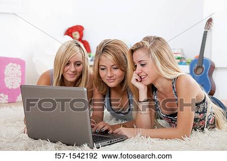 Teenage girls with laptop View Large Photo Image Stock Image - Teenage girls with laptop. Fotosearch