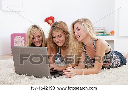 Teenage girls with laptop View Large Photo Image Stock Image - Teenage girls with laptop. Fotosearch