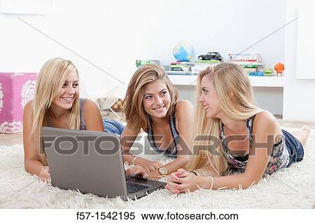 Teenage girls with laptop View Large Photo Image Stock Photography - Teenage girls with laptop. Fotosearch