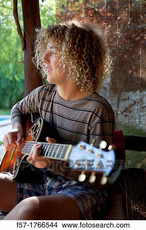 Teenage musician with his guitar View Large Photo Image Picture - Teenage musician with his guitar. Fotosearch
