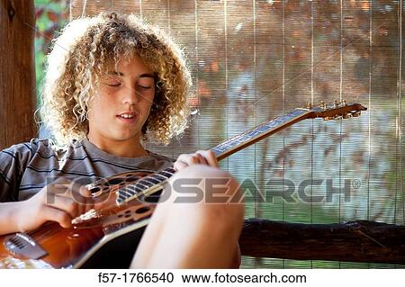 Teenage musician with his guitar View Large Photo Image Stock Image - Teenage musician with his guitar. Fotosearch