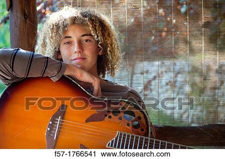 Teenage musician with his guitar View Large Photo Image Stock Image - Teenage musician with his guitar. Fotosearch