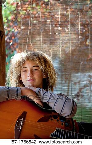 Teenage musician with his guitar View Large Photo Image Stock Image - Teenage musician with his guitar. Fotosearch