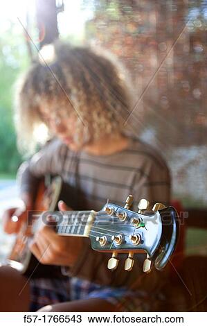 Teenage musician with his guitar View Large Photo Image Stock Image - Teenage musician with his guitar. Fotosearch
