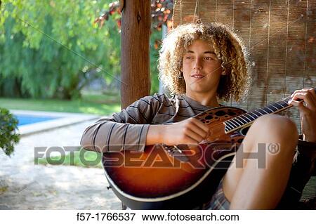 Stock Photo - Teenage musician with his guitar. Fotosearch