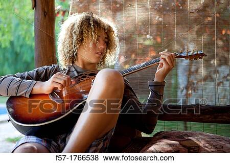 Teenage musician with his guitar View Large Photo Image Stock Photo - Teenage musician with his guitar. Fotosearch