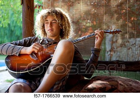Teenage musician with his guitar View Large Photo Image Stock Photo - Teenage musician with his guitar. Fotosearch