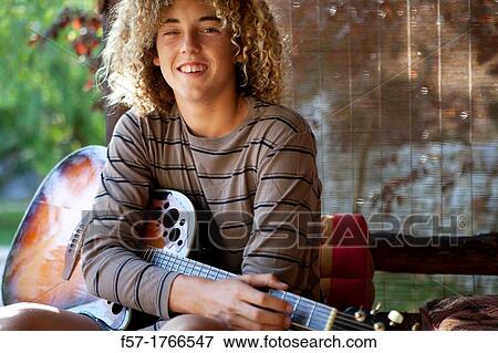 Teenage musician with his guitar View Large Photo Image Stock Photo - Teenage musician with his guitar. Fotosearch