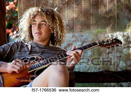 Teenage musician with his guitar View Large Photo Image Stock Photograph - Teenage musician with his guitar. Fotosearch