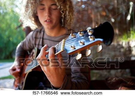 Teenage musician with his guitar View Large Photo Image Stock Photograph - Teenage musician with his guitar. Fotosearch