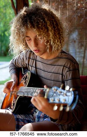 Teenage musician with his guitar View Large Photo Image Stock Photography - Teenage musician with his guitar. Fotosearch