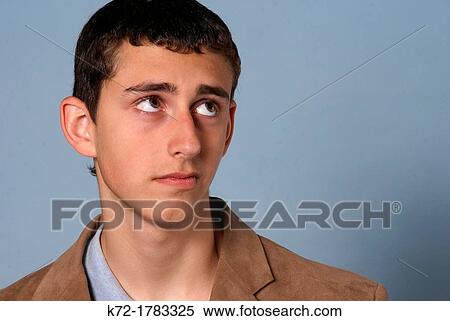 Teenage young man looking up with a worried expression View Large Photo Image Stock Photography - Teenage young man looking up with a worried expression. Fotosearch