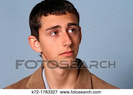 Stock Photo - Teenage young man with a sad but thoughtful look. Fotosearch