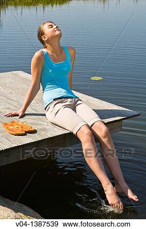 Teenaged girl enjoing the sunshine outdoors at a lake, Germany, Europe View Large Photo Image Stock Photo - Teenaged girl enjoing the sunshine outdoors at a lake, Germany, Europe. Fotosearch