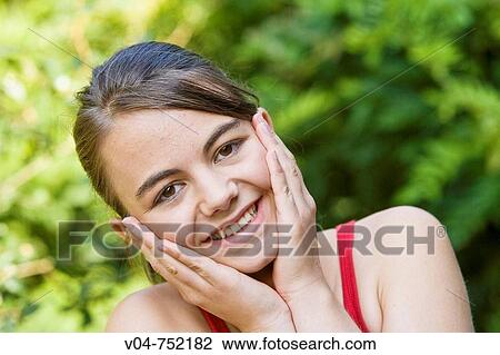 Teenaged girl looking happy outdoors in the garden View Large Photo Image Stock Image - Teenaged girl looking happy outdoors in the garden. Fotosearch
