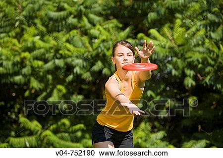 Teenaged girl playing frisbee outdoors in a garden View Large Photo Image Stock Image - Teenaged girl playing frisbee outdoors in a garden. Fotosearch