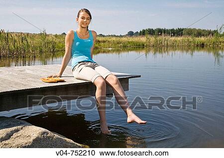 Teenaged girl relaxing and sunbathing at a lake View Large Photo Image Stock Image - Teenaged girl relaxing and sunbathing at a lake. Fotosearch