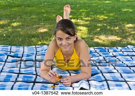 Teenaged girl ripping flower petals and smiling at the camera, Germany, Europe View Large Photo Image Stock Image - Teenaged girl ripping flower petals and smiling at the camera, Germany, Europe. Fotosearch