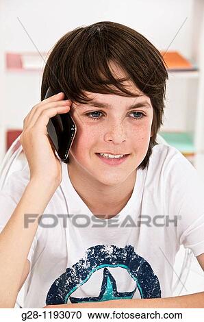 Teenager boy happy on the phone at home indoor View Large Photo Image Stock Image - Teenager boy happy on the phone at home indoor. Fotosearch