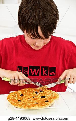 teenager boy in a red T-shirt, eating a pizza at home View Large Photo Image Stock Photo - teenager boy in a red T-shirt, eating a pizza at home. Fotosearch