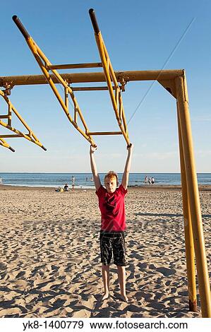 Teenager Boy Swinging on P? rnu Beach, Estonia View Large Photo Image Stock Photo - Teenager Boy Swinging on P? rnu Beach, Estonia. Fotosearch