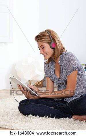 Teenager communicating with a digital tablet View Large Photo Image Picture - Teenager communicating with a digital tablet. Fotosearch