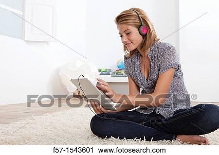 Stock Image - Teenager communicating with a digital tablet. Fotosearch