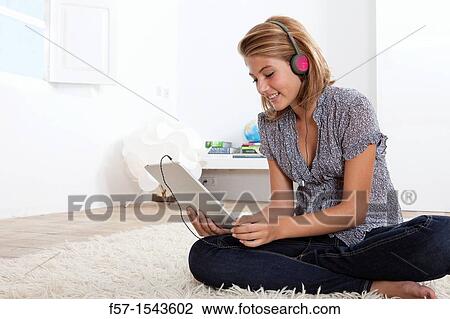Stock Image - Teenager communicating with a digital tablet. Fotosearch