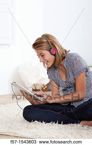 Stock Image - Teenager communicating with a digital tablet. Fotosearch