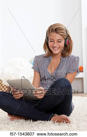 Teenager communicating with a digital tablet View Large Photo Image Stock Photo - Teenager communicating with a digital tablet. Fotosearch