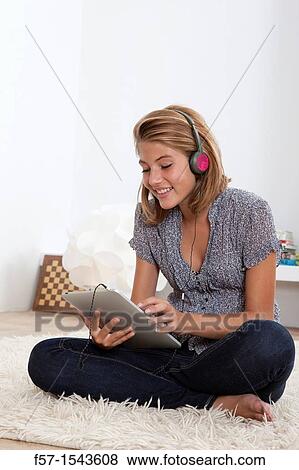 Teenager communicating with a digital tablet View Large Photo Image Stock Photo - Teenager communicating with a digital tablet. Fotosearch